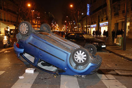 An overturned vehicle is seen during a demonstration against the Israeli air strikes on Gaza, in Paris 